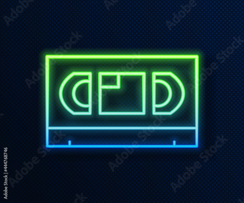 Glowing neon line VHS video cassette tape icon isolated on blue background. Vector
