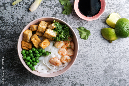 asian rice noodle soup with fried tofu and shrimps