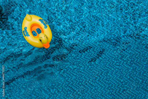 Children's swimming circle. Relaxing by the pool. Swimming circle in the form of a duck. Top view