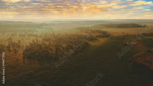 Beautiful landscape aerial view at sunrise on a foggy morning in the countryside