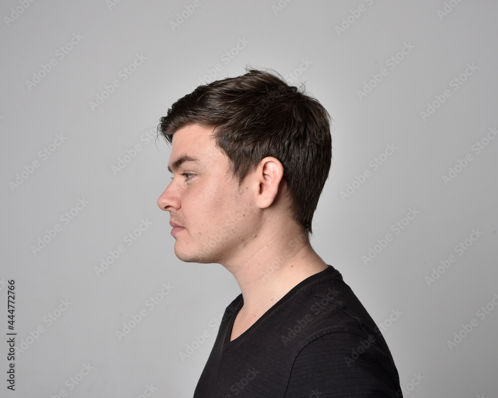 Close up head and shoulders portrait of a brunette. young man with a variety of expressive facial expressions. Isolated on a light grey studio background. Close up head and shoulders portrait of a brunette. young man with a variety of expressive facial expressions. Isolated on a light grey studio background.