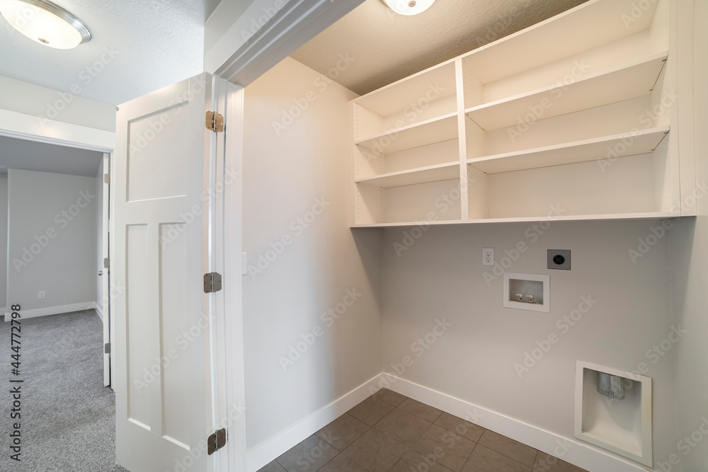 Interior of an empty laundry room with folding door Interior of an empty laundry room with folding door
