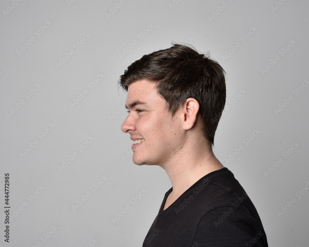 Close up head and shoulders portrait of a brunette. young man with a variety of expressive facial expressions. Isolated on a light grey studio background. Close up head and shoulders portrait of a brunette. young man with a variety of expressive facial expressions. Isolated on a light grey studio background.