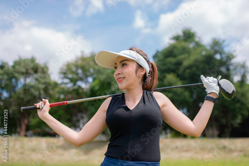 Portrait of golfer asian woman holding golf wood at the country club,Happy woman concept