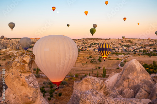 Hot air balloons floating over mountains in Cappadocia, Turkey