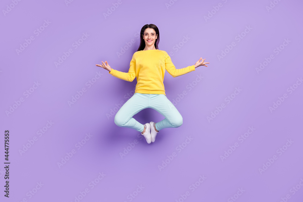 Full length photo of positive happy relaxed woman jump up asana make om sign isolated on purple color background