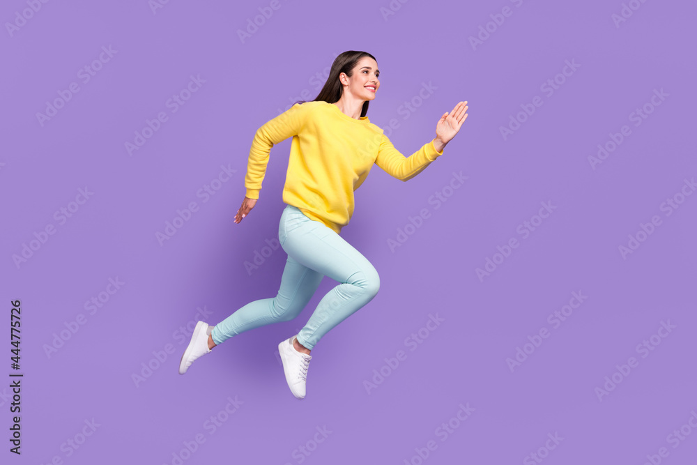 Full length body size view of attractive cheerful motivated girl jumping running isolated over violet purple color background