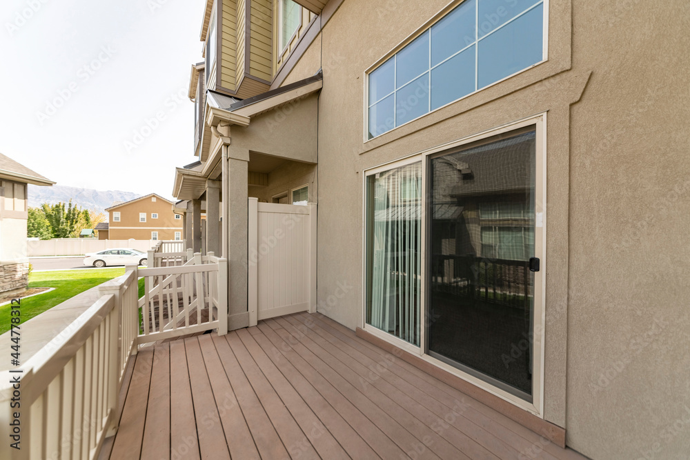 Fototapeta premium Exterior of a house on a wooden deck with sliding glass door