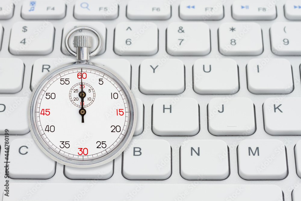 Fototapeta premium Stopwatch 60 seconds on gray keyboard