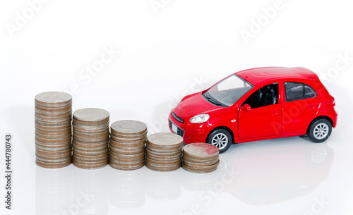 Red miniature car on coin stack : Car loan and leasing time concepts. Car insurance. car model and financial with coins.