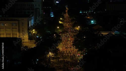 Aerial shot of many runners running on the street at night of Ho Chi Minh City, Vietnam photo