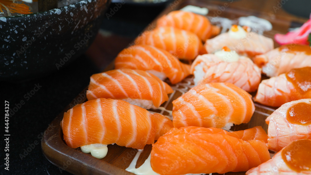 Salmon Sushi Japanese food. on the table in restaurant. Japanese cuisine set of Sashimi Salmon sushi nigiri. Salmon Sushi Japanese food. on the table in restaurant. Japanese cuisine set of Sashimi Salmon sushi nigiri.