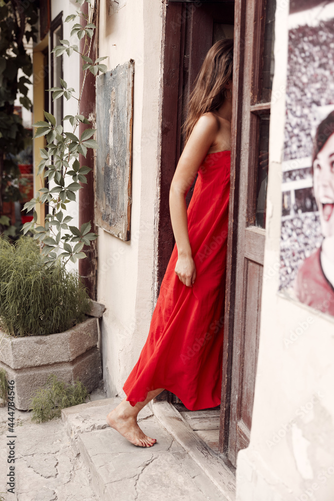 Charming Spaniard wanders the streets in a red long dress