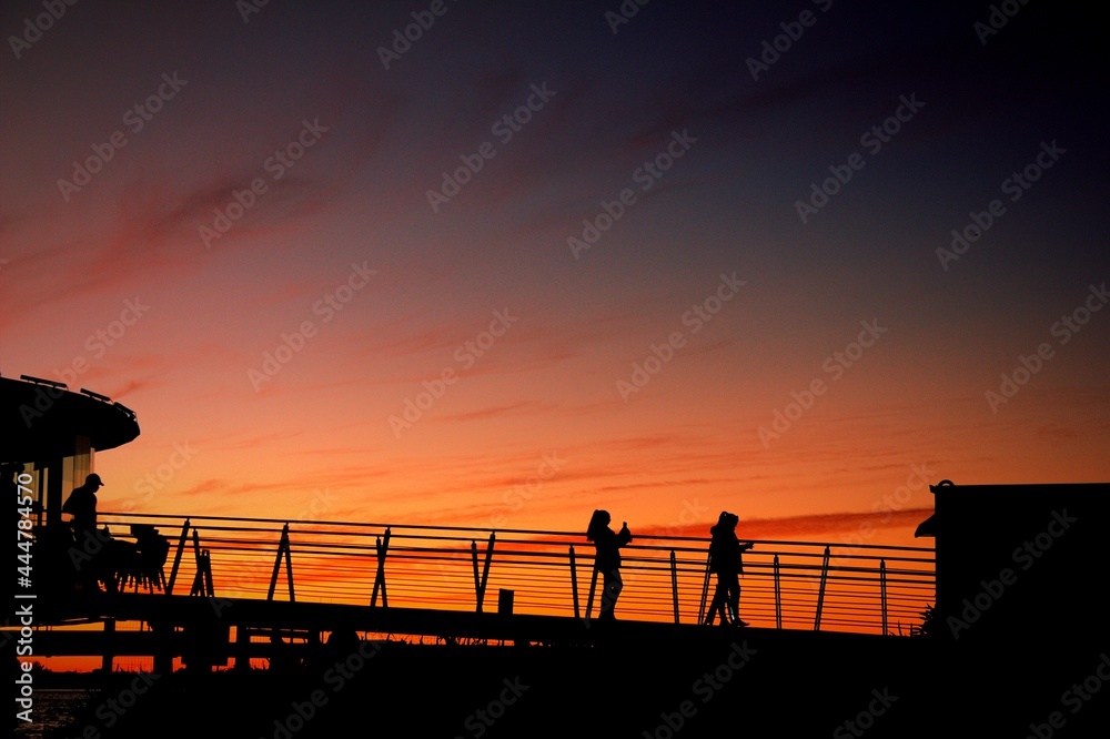 silhouette of a person on a bridge silhouette of a person on a bridge