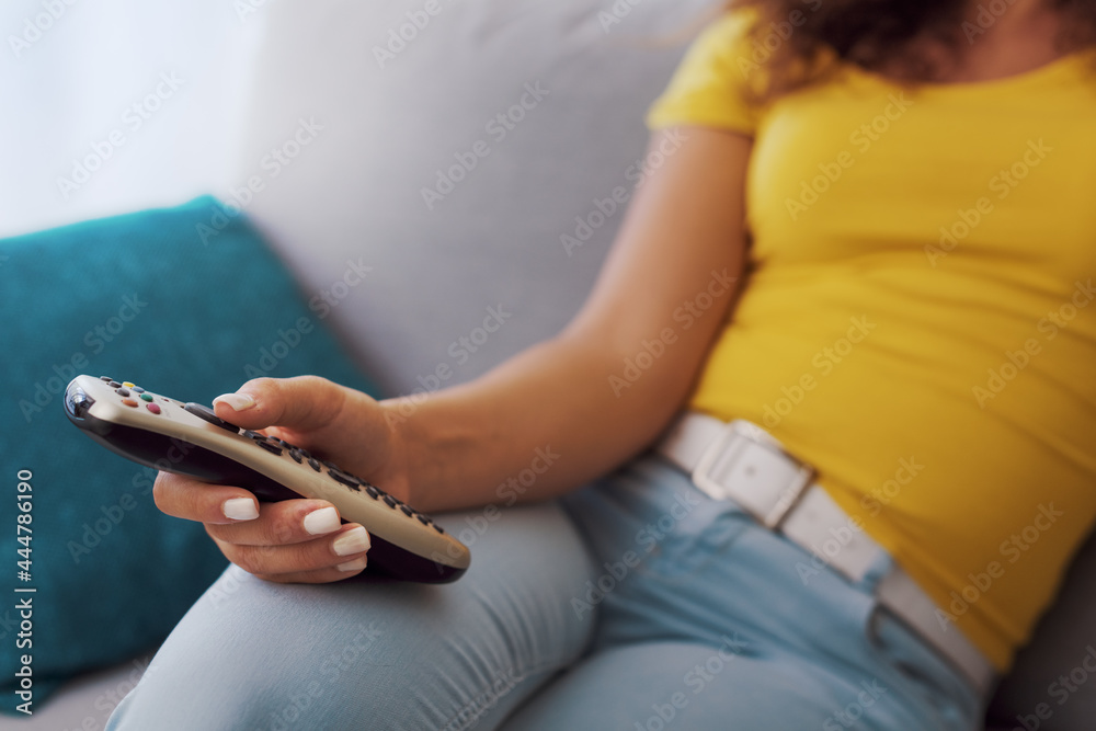 Woman relaxing on the sofa and watching TV