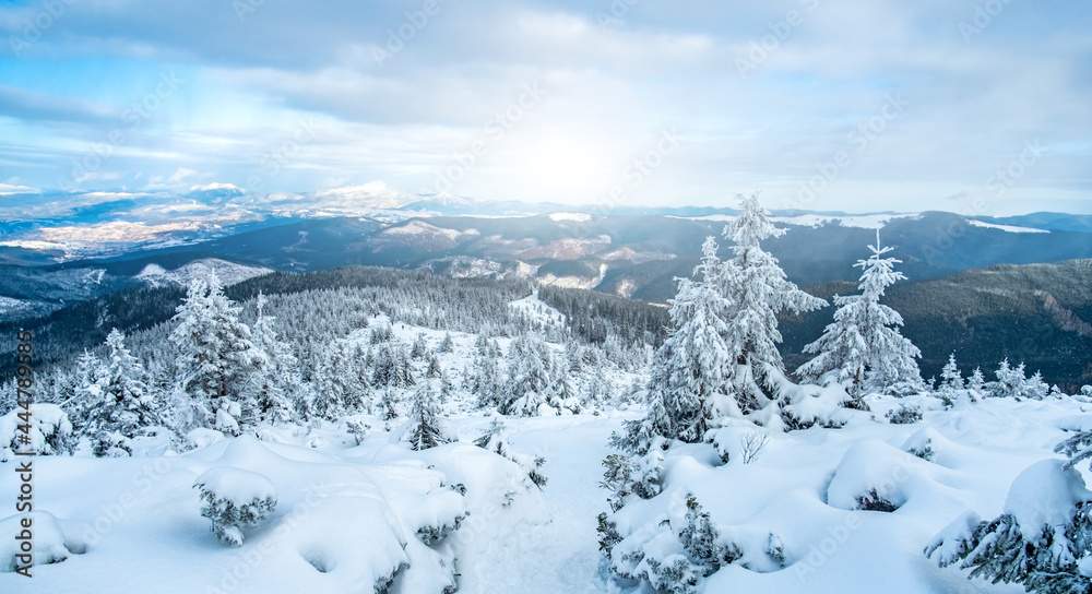 Landscape of snowy mountain range under winter sun