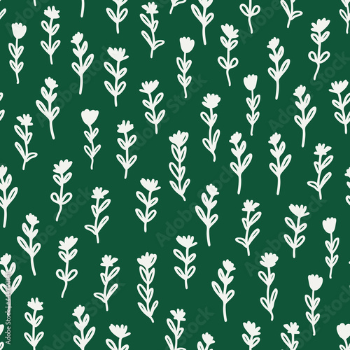 Doodled flowers with leaves seamless repeat pattern. Irregular vector botanical elements all over surface print on green background. © MoJX.Studio