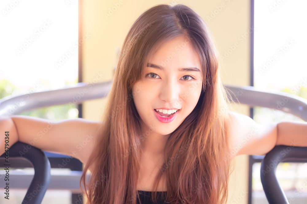 Portrait beauty young asian woman smiling and looking camera with relax and happy Portrait smiling beautiful girl Happy cheerful female stay at fitness center Pretty young lady has lovely face