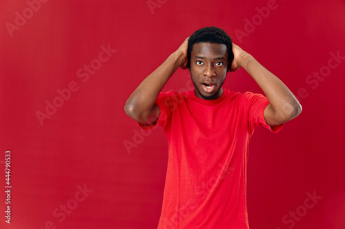 man of african appearance in red t-shirt isolated background emotions