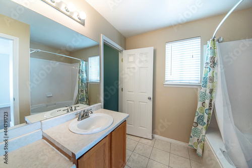 Interior of a bathroom with ceramic tile flooring and window