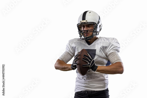 Close-up young American football player, athlete posing isolated on white studio background. Concept of professional sport, championship, competition.