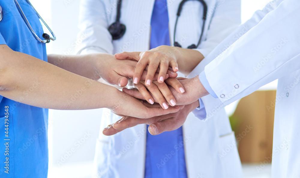 Group of doctors putting their hands together. Close-up Group of doctors putting their hands together. Close-up