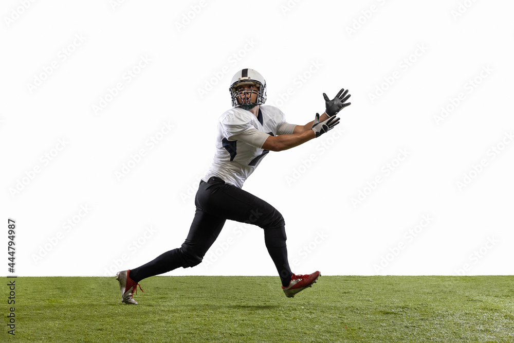 American football player in action isolated on white studio background. Concept of professional sport, championship, competition. American football player in action isolated on white studio background. Concept of professional sport, championship, competition.