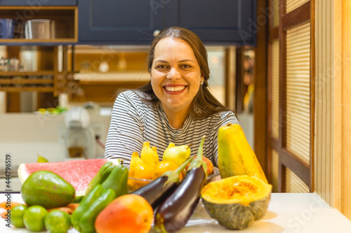 woman in the kitchen with fruint and vegetables photo