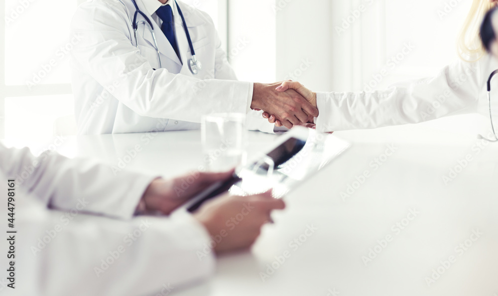 Team of doctors having consultation in clinic Team of doctors having consultation in clinic