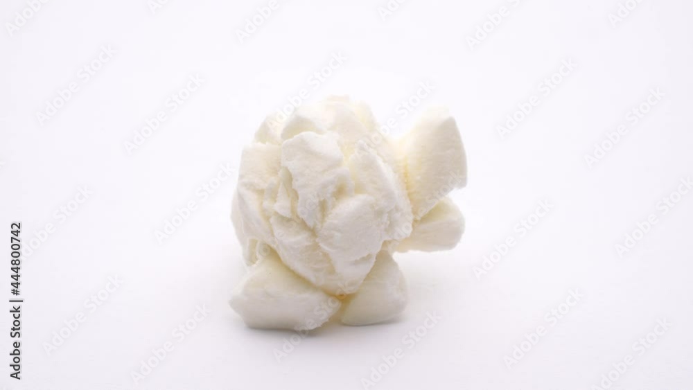 Macro shooting of one popcorn. Rotating on white background. Macro shooting of one popcorn. Rotating on white background.