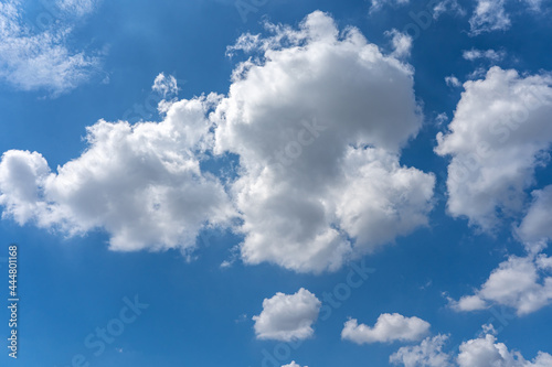 Big white cloud cumulus floating on the blue sky for backgrounds concept