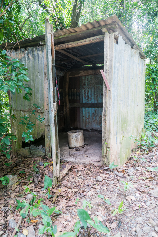 old abandoned steel and wood outhouse in the countryside of the Caribbean mountains in the Dominican Republic. old abandoned steel and wood outhouse in the countryside of the Caribbean mountains in the Dominican Republic.