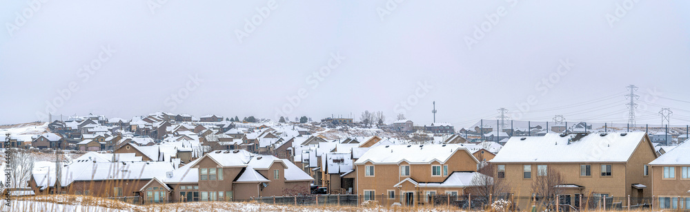 Big and beautiful houses with white roofs with the white cloudy sky Big and beautiful houses with white roofs with the white cloudy sky