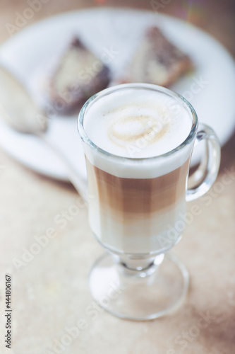 Coffee with milk on bright stone background. Close up. 