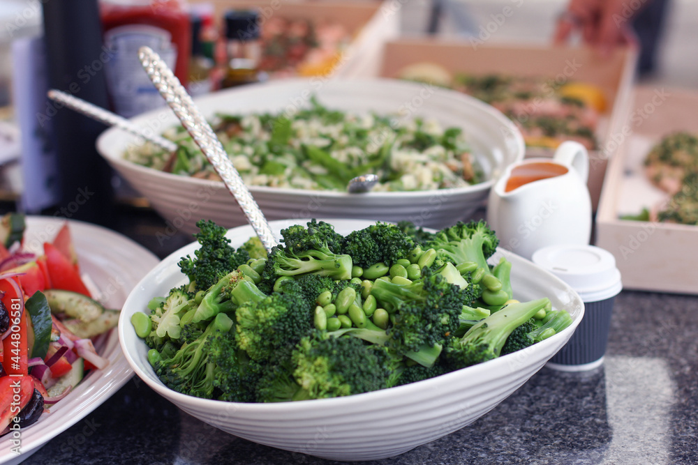 Bowl of superfood green vegetables on a table including broccoli and peas Bowl of superfood green vegetables on a table including broccoli and peas