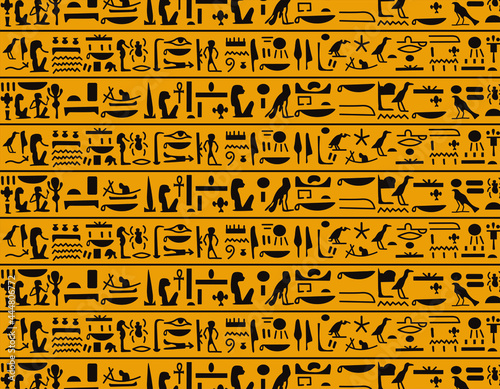Ancient dark brown egyptian hieroglyphs alphabet pattern over yellow background. Ancient egyptian and ancient culture concept