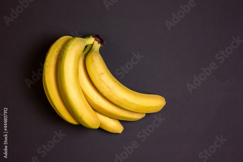 Bananas on a black background. Svzyaka bananas. Yellow bananas.
