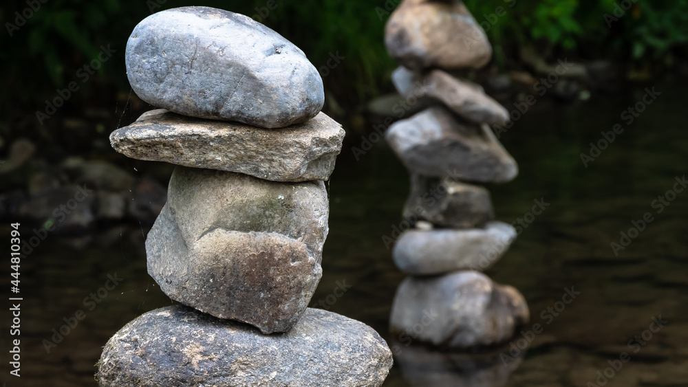 Rough Stone Cairns Standing Proudly in the Shallow Creek Water Rough Stone Cairns Standing Proudly in the Shallow Creek Water
