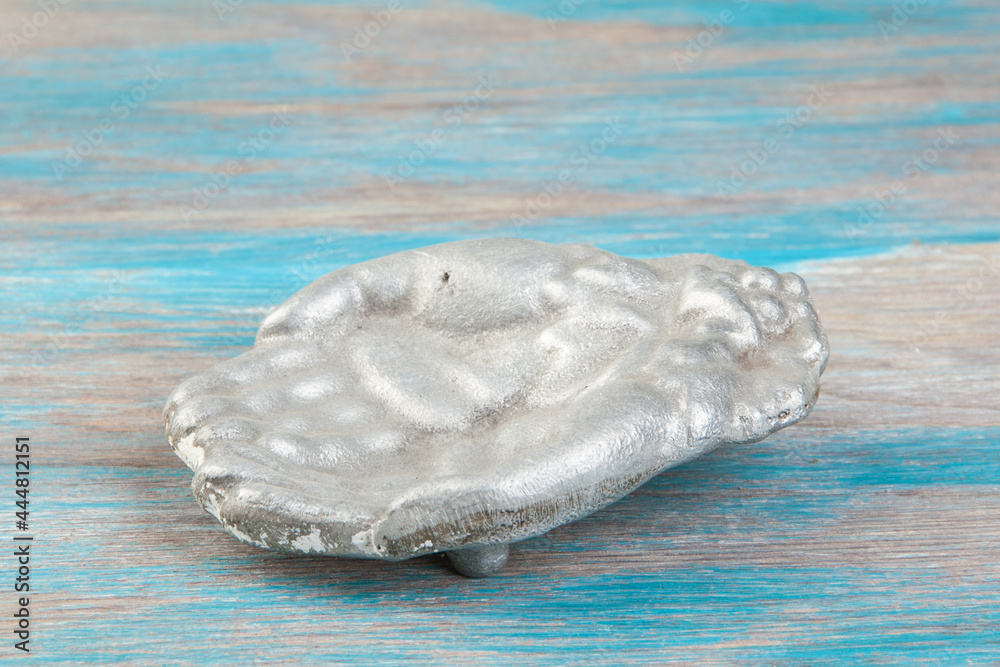 Old aluminum bird feeder on blue wooden background. Old aluminum bird feeder on blue wooden background.