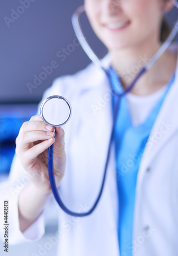 Close-up shot of doctor's hands holding stethoscope at clinic.