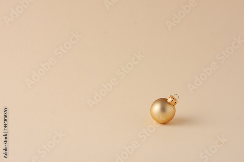 Christmas pastel beige minimal background with beige ball. Close up  copy space