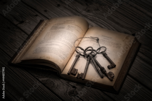 Libro antiguo abierto y con un juego de llaves de hierro cogidas con un aro de alambre .