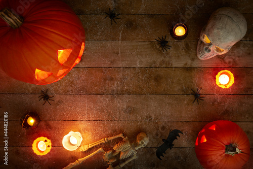 glowing pumpkins on a dark wooden cobweb background