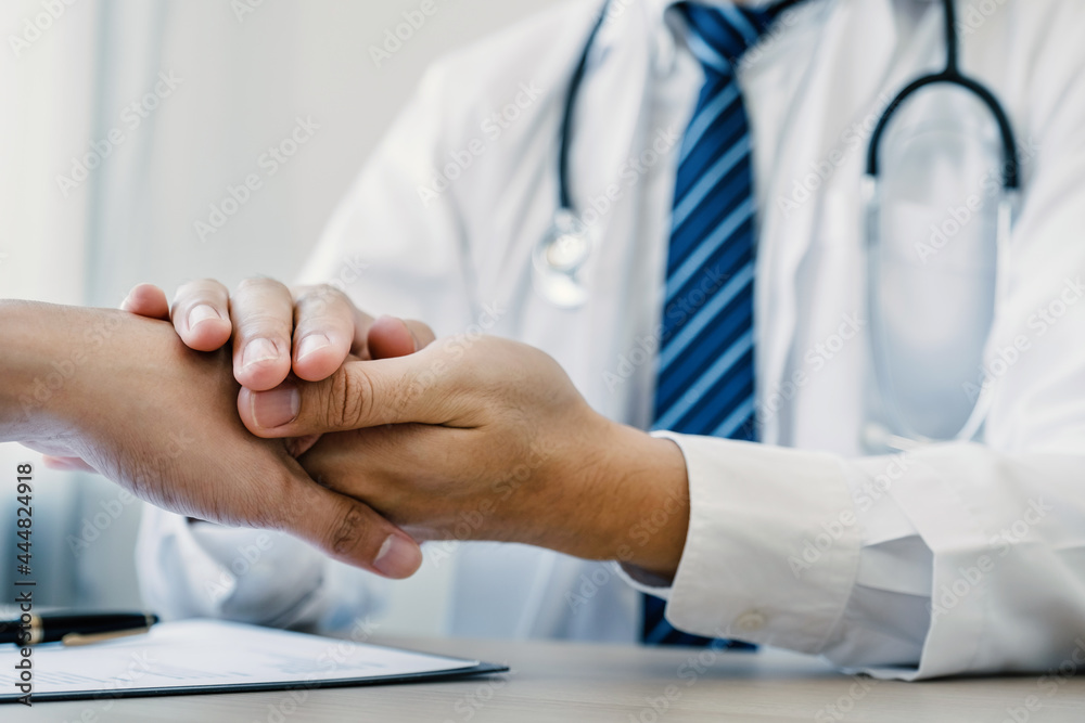 Doctor hands holding patient hand to encourage and explained the health examination results, medical checkup concept Doctor hands holding patient hand to encourage and explained the health examination results, medical checkup concept