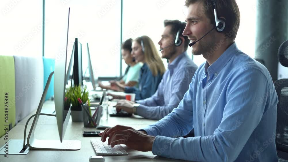 Male representative call center agent in wireless headset helping client, operator working in customer support service