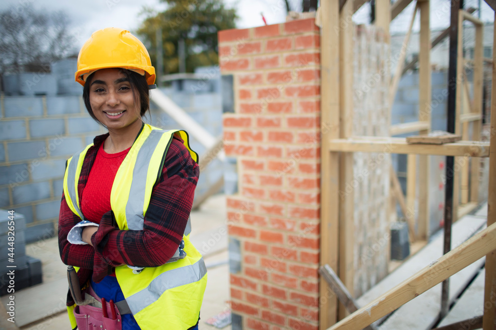 © Paul Bradbury/Caia Image - Portrait confident female construction site at construction site © Paul Bradbury/Caia Image - Portrait confident female construction site at construction site