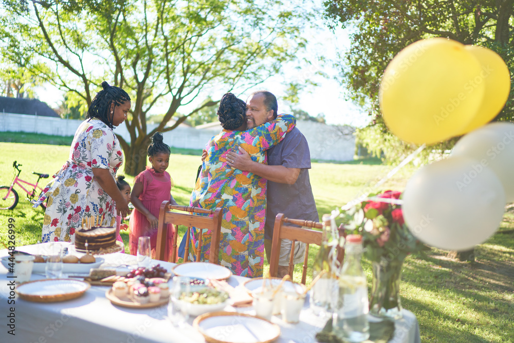 Happy multigenerational family celebrating birthday in summer backyard Happy multigenerational family celebrating birthday in summer backyard