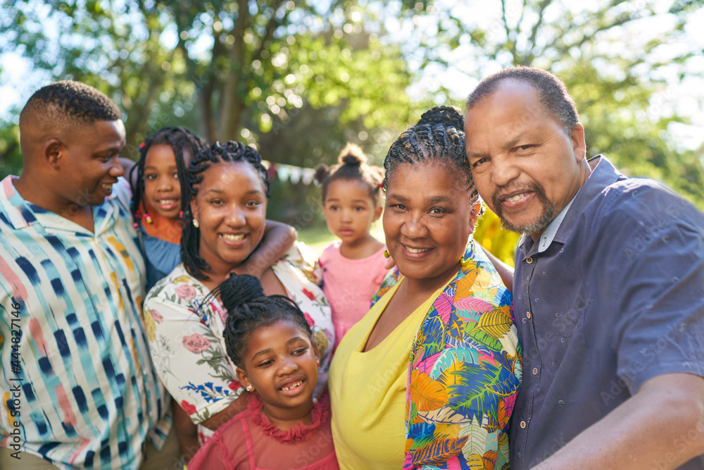 Portrait happy multigenerational family in summer park Portrait happy multigenerational family in summer park