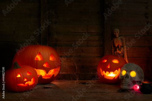 glowing pumpkins on a dark wooden cobweb background