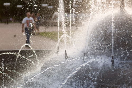 Fototapeta Naklejka Na Ścianę i Meble -  Hot summer in the city.Fountain on the city street in summer.